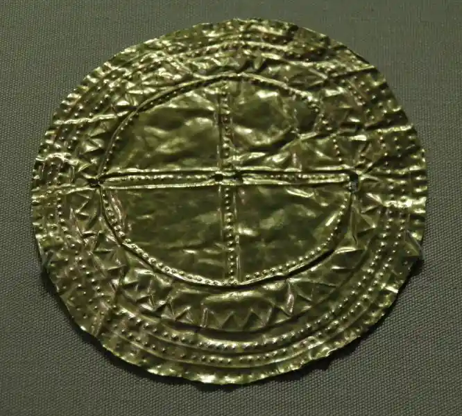 Pre-christian cross design inside the sun on a gold sheet